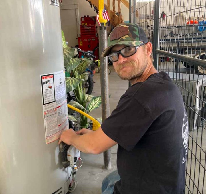 A skilled technician performing water heater repair and maintenance